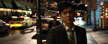 Movie still from “A Very Harold & Kumar Christmas” (2011), directed by Todd Strauss-Schulson – A man wearing a suit and tie standing on the side of the street; Close Up shot, Over the shoulder angle