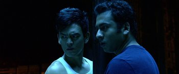 Movie still from “A Very Harold & Kumar Christmas” (2011), directed by Todd Strauss-Schulson – Two men standing next to each other in front of a door; Close Up shot, Over the shoulder angle