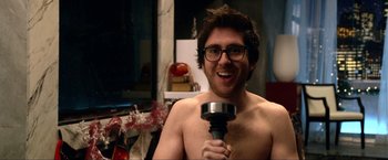 Movie still from “A Very Harold & Kumar Christmas” (2011), directed by Todd Strauss-Schulson – A man with glasses is holding an object; Close Up shot, Over the shoulder angle