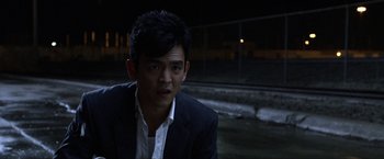 Movie still from “A Very Harold & Kumar Christmas” (2011), directed by Todd Strauss-Schulson – A man wearing a suit and a white dress shirt; Close Up shot, Over the shoulder angle