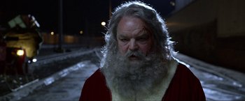 Movie still from “A Very Harold & Kumar Christmas” (2011), directed by Todd Strauss-Schulson – An old man with a beard and a red jacket; Close Up shot, Over the shoulder angle