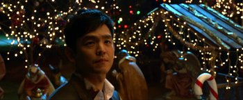 Movie still from “A Very Harold & Kumar Christmas” (2011), directed by Todd Strauss-Schulson – A man standing in front of a christmas tree; Close Up shot, Over the shoulder angle