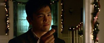 Movie still from “A Very Harold & Kumar Christmas” (2011), directed by Todd Strauss-Schulson – A man in a suit and tie pointing to his face; Close Up shot, Over the shoulder angle