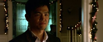 Movie still from “A Very Harold & Kumar Christmas” (2011), directed by Todd Strauss-Schulson – A person wearing a suit and tie; Close Up shot, Low angle