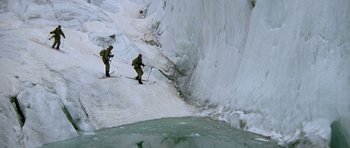 Movie still from “A View to a Kill” (1985), directed by John Glen – Two skiers are going down a snowy slope; Wide shot, High angle