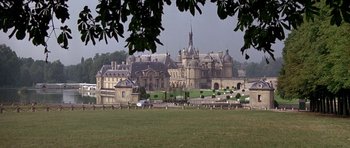 Movie still from “A View to a Kill” (1985), directed by John Glen – A large building with a large lawn in front of it; Extreme Wide shot, High angle