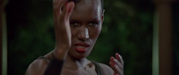 Movie still from “A View to a Kill” (1985), directed by John Glen – A person holding their hand up; Close Up shot, Low angle