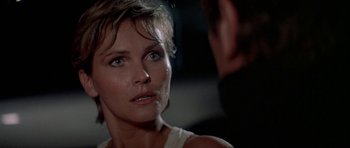 Movie still from “A View to a Kill” (1985), directed by John Glen – A person with a face covered in water; Close Up shot, Over the shoulder angle