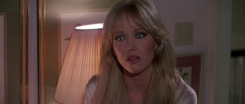 Movie still from “A View to a Kill” (1985), directed by John Glen – A person with long blonde hair; Close Up shot, Over the shoulder angle
