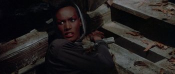 Movie still from “A View to a Kill” (1985), directed by John Glen – A person with a knife in their hand; Close Up shot, Overhead angle