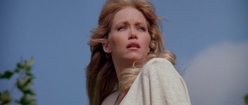 Movie still from “A View to a Kill” (1985), directed by John Glen – A woman with long blonde hair is looking up; Close Up shot, Low angle