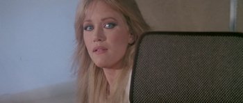 Movie still from “A View to a Kill” (1985), directed by John Glen – A person sitting in a car; Close Up shot, Over the shoulder angle