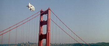 Movie still from “A View to a Kill” (1985), directed by John Glen – A plane flying over the golden gate bridge in san francisco; Extreme Wide shot, Low angle