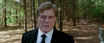 Movie still from “A Walk in the Woods” (2015), directed by Ken Kwapis – An older man wearing a suit and tie in a wooded area; Close Up shot, Low angle