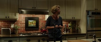 Movie still from “A Walk in the Woods” (2015), directed by Ken Kwapis – A woman standing in a kitchen next to a sink; Medium shot, Over the shoulder angle
