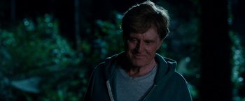 Movie still from “A Walk in the Woods” (2015), directed by Ken Kwapis – An older man in a green jacket looking down at the ground; Close Up shot, Over the shoulder angle