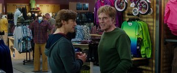 Movie still from “A Walk in the Woods” (2015), directed by Ken Kwapis – Two men are talking in a clothing store; Medium shot, Over the shoulder angle