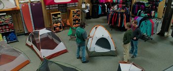 Movie still from “A Walk in the Woods” (2015), directed by Ken Kwapis – A person standing in a room next to two tents; Wide shot, High angle