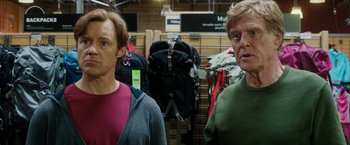 Movie still from “A Walk in the Woods” (2015), directed by Ken Kwapis – Two people standing next to each other in front of backpacks; Medium shot, Over the shoulder angle