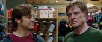 Movie still from “A Walk in the Woods” (2015), directed by Ken Kwapis – Two men standing next to each other in a store; Close Up shot, Over the shoulder angle