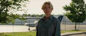 Movie still from “A Walk in the Woods” (2015), directed by Ken Kwapis – A woman standing in front of an airplane in a parking lot; Close Up shot, Over the shoulder angle