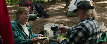 Movie still from “A Walk in the Woods” (2015), directed by Ken Kwapis – Two people sitting on a bench eating food; Medium shot, Over the shoulder angle