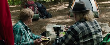 Movie still from “A Walk in the Woods” (2015), directed by Ken Kwapis – Two people sitting on the ground eating food; Medium shot, Over the shoulder angle