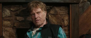 Movie still from “A Walk in the Woods” (2015), directed by Ken Kwapis – An older man wearing a plaid shirt in front of a stone wall; Close Up shot, Low angle