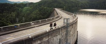 Movie still from “A Walk in the Woods” (2015), directed by Ken Kwapis – Two people are walking on the side of a bridge; Extreme Wide shot, High angle