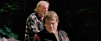Movie still from “A Walk in the Woods” (2015), directed by Ken Kwapis – A man sitting on the shoulder of another man; Medium shot, Low angle