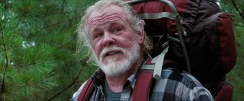 Movie still from “A Walk in the Woods” (2015), directed by Ken Kwapis – An older man with a beard and a backpack; Close Up shot, Over the shoulder angle