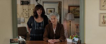 Movie still from “A Walk in the Woods” (2015), directed by Ken Kwapis – A woman standing next to an older woman at a table; Medium shot, Over the shoulder angle