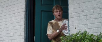 Movie still from “A Walk in the Woods” (2015), directed by Ken Kwapis – A man standing in front of a green door; Medium shot, Over the shoulder angle
