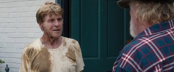 Movie still from “A Walk in the Woods” (2015), directed by Ken Kwapis – A man in a brown shirt is talking to another man in a cowboy hat; Medium shot, Over the shoulder angle