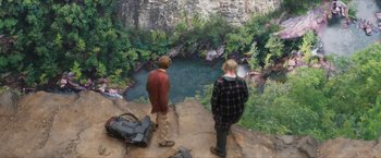 Movie still from “A Walk in the Woods” (2015), directed by Ken Kwapis – Two young men are standing on a ledge looking at a mural; Extreme Wide shot, Overhead angle
