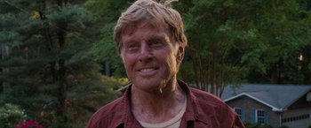 Movie still from “A Walk in the Woods” (2015), directed by Ken Kwapis – An older man with blonde hair smiling for the camera; Close Up shot, Over the shoulder angle