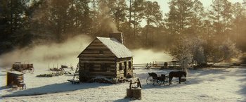 Movie still from “Abraham Lincoln: Vampire Hunter” (2012), directed by Timur Bekmambetov – An old log cabin in the middle of a snowy field; Extreme Wide shot, High angle