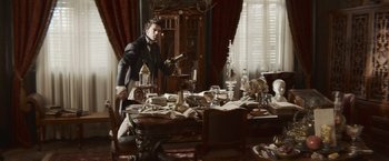 Movie still from “Abraham Lincoln: Vampire Hunter” (2012), directed by Timur Bekmambetov – A man standing in front of a dining room table; Wide shot, High angle