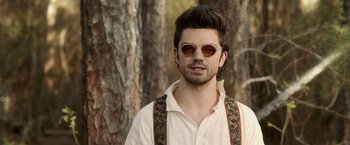 Movie still from “Abraham Lincoln: Vampire Hunter” (2012), directed by Timur Bekmambetov – A young man wearing sunglasses and suspenders in front of trees; Close Up shot, Over the shoulder angle