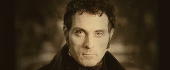 Movie still from “Abraham Lincoln: Vampire Hunter” (2012), directed by Timur Bekmambetov – A man in a black jacket is looking at the camera; Close Up shot, High angle