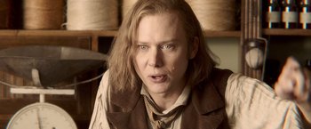 Movie still from “Abraham Lincoln: Vampire Hunter” (2012), directed by Timur Bekmambetov – A man with long blonde hair wearing a suit and tie; Close Up shot, Over the shoulder angle