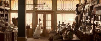 Movie still from “Abraham Lincoln: Vampire Hunter” (2012), directed by Timur Bekmambetov – A woman in a white dress standing in front of a window; Wide shot, Low angle