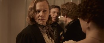 Movie still from “Abraham Lincoln: Vampire Hunter” (2012), directed by Timur Bekmambetov – A man with long hair wearing a suit and a tie; Close Up shot, Over the shoulder angle