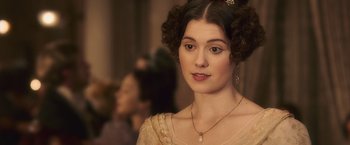 Movie still from “Abraham Lincoln: Vampire Hunter” (2012), directed by Timur Bekmambetov – A beautiful young lady wearing a gold dress and pearls; Close Up shot, Over the shoulder angle