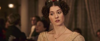 Movie still from “Abraham Lincoln: Vampire Hunter” (2012), directed by Timur Bekmambetov – A woman in a dress with a necklace and earrings; Close Up shot, Over the shoulder angle