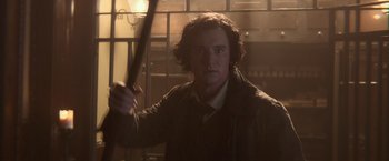 Movie still from “Abraham Lincoln: Vampire Hunter” (2012), directed by Timur Bekmambetov – A man holding a wooden stick in a room; Close Up shot, Over the shoulder angle