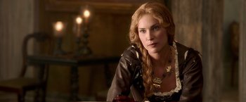 Movie still from “Abraham Lincoln: Vampire Hunter” (2012), directed by Timur Bekmambetov – A woman with long blonde hair sitting at a table; Close Up shot, Over the shoulder angle