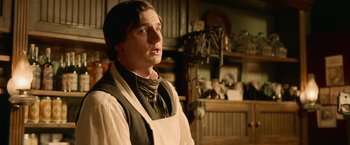 Movie still from “Abraham Lincoln: Vampire Hunter” (2012), directed by Timur Bekmambetov – A man wearing a white apron standing in a kitchen; Medium shot, Over the shoulder angle