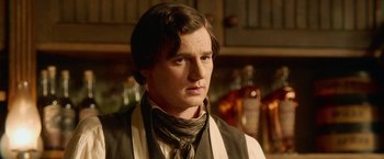 Movie still from “Abraham Lincoln: Vampire Hunter” (2012), directed by Timur Bekmambetov – A man in a suit and tie standing in a room; Close Up shot, Over the shoulder angle