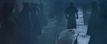 Movie still from “Abraham Lincoln: Vampire Hunter” (2012), directed by Timur Bekmambetov – A man standing next to a coffin in a dark room; Wide shot, Over the shoulder angle